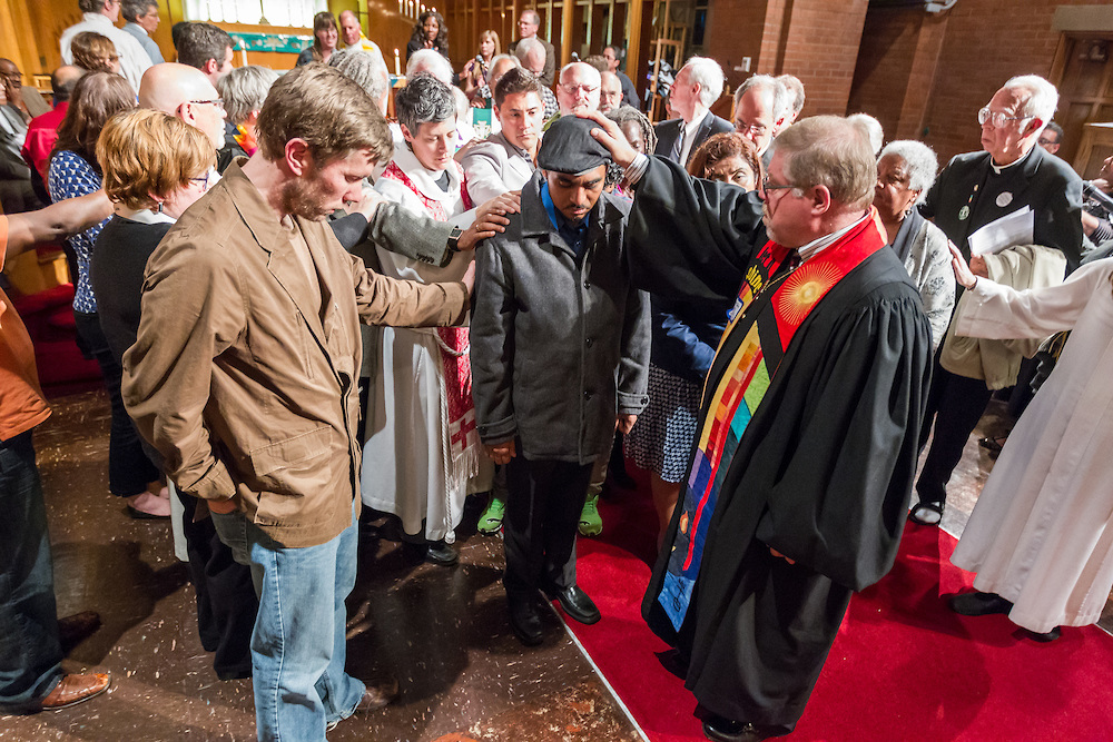 A wide spectrum of Portland, Ore., faith leaders pray with Francisco Aguirre at the  
